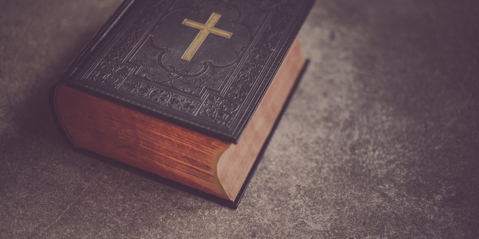 black Bible on gray surface