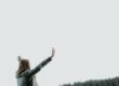 woman raising her hands