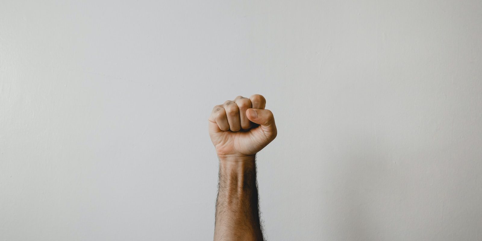 persons right foot on white wall