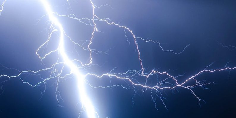 lightning strike during blue sky